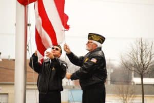 Members of the VFW raise the flag at Alpine Shop O'Fallon's Grand Opening celebration on Friday, March 22.