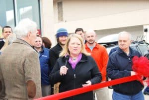 Owner Lisa Hollenbeck addresses the crowd at the ribbon cutting ceremony for Alpine Shop O'Fallon's Grand Opening celebration on Friday, March 22.